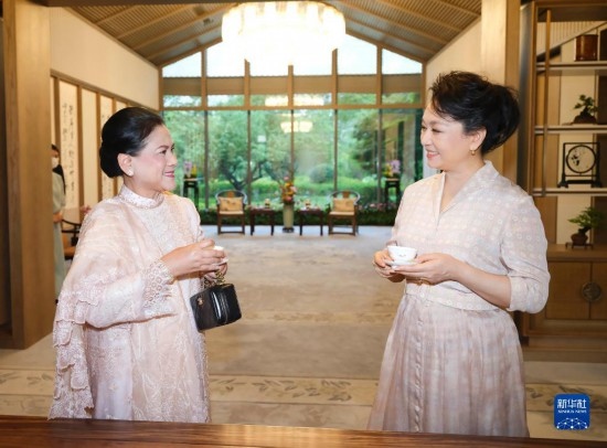  7月27日下午，國家主席習(xí)近平夫人彭麗媛在四川成都會見陪同印度尼西亞總統(tǒng)佐科來華出席第31屆世界大學(xué)生夏季運動會開幕式并訪華的總統(tǒng)夫人伊莉亞娜。這是彭麗媛邀請伊莉亞娜觀看茶藝表演，并同伊莉亞娜親切茶敘。新華社記者 丁林 攝