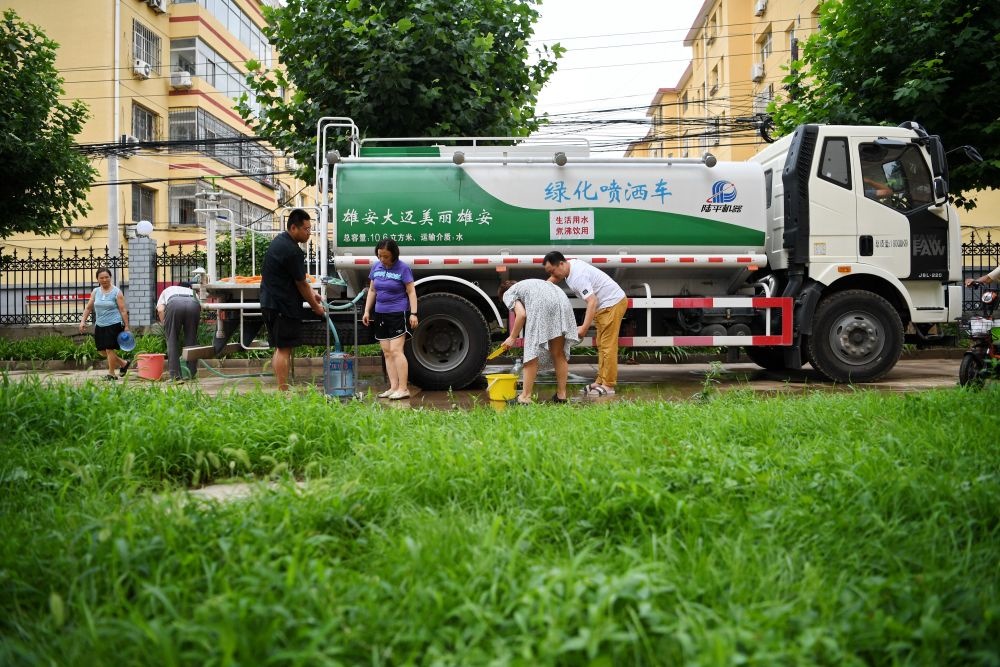 河北省涿州市新星小區(qū)居民從供水車?yán)锝铀?月4日攝）。新華社記者 牟宇 攝