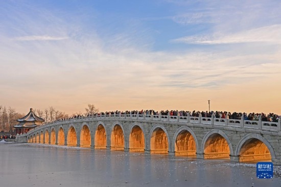 這是12月22日拍攝的頤和園十七孔橋“金光穿洞”景象。