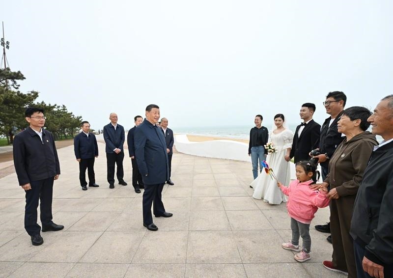 5月22日，在山東日照考察調(diào)研的習(xí)近平總書記來到陽光海岸綠道，同市民游客親切交流。