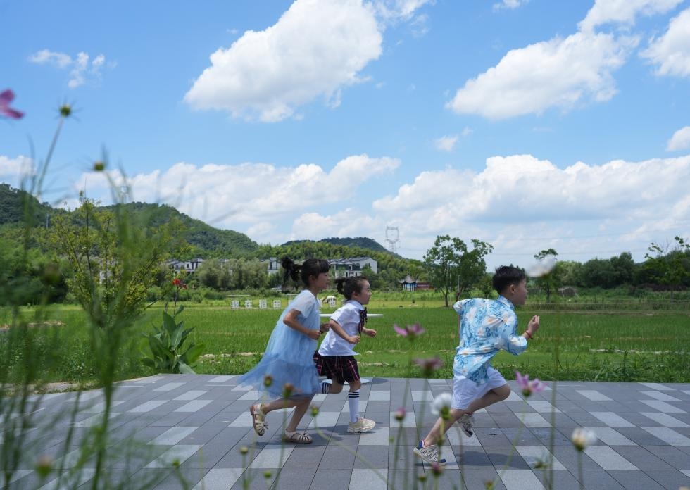 兒童在余姚市梁弄鎮(zhèn)的田野間奔跑（7月3日攝）。新華社記者翁忻旸 攝